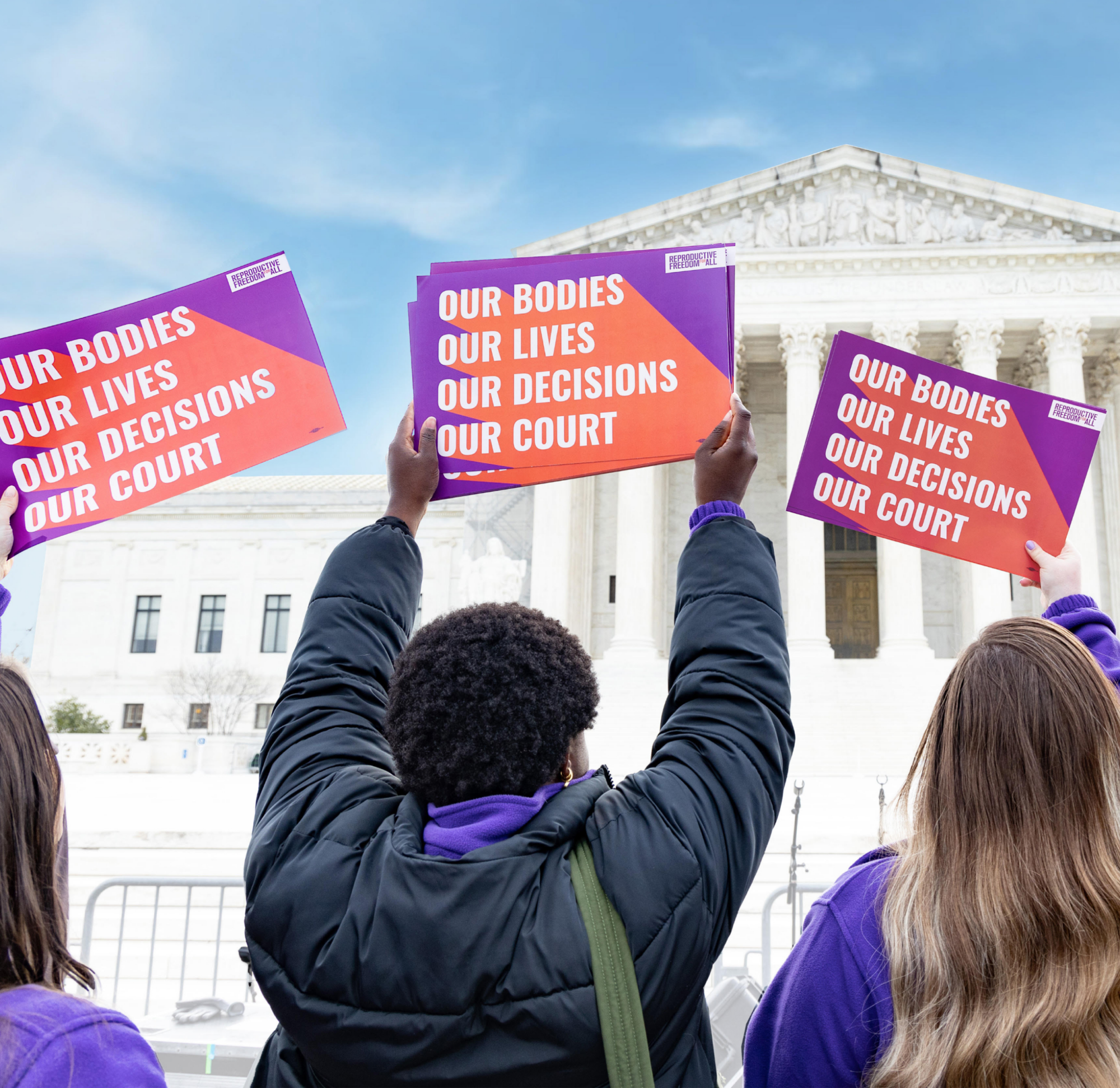 Repro for All Foundation Annual Report hero image featuring four reproductive freedom supporters at a rally before the U.S. Supreme Court, holding signs that say, “Our Bodies, Our Lives, Our Decisions, Our Courts.”